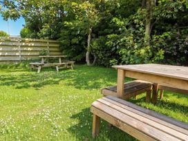 A garden with tables and benches at Porth Ewyn in Trearddur Bay