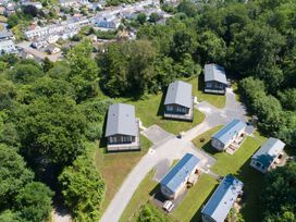 An outdoor area with several houses and trees at 2 Manleigh Park in Combe Martin
