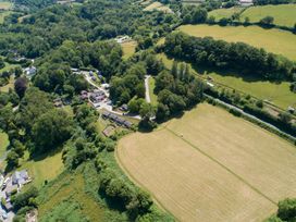 An aerial view of a residential area with fields and trees at 6 Manleigh Park Combe Martin