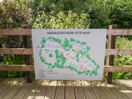 A map of Manleigh Park showing chalets log cabins lodges caravans bungalows reception laundry fire points and dog walking areas