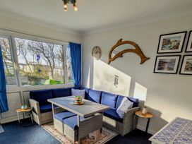 A snug with a blue sofa and table at 21 The Glade in Kilkhampton