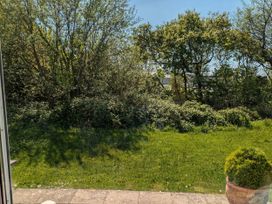A garden with trees and grass at 21 The Glade in Kilkhampton