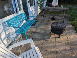 An outdoor patio with seating and a fire pit at 21 The Glade Kilkhampton