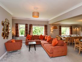 A living room with a sofa and dining area at Hazelgarth House in Hunmanby