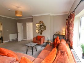 A living room with a sofa and armchair at Hazelgarth House in Hunmanby
