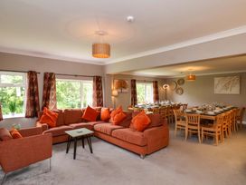 A dining room with a sofa and dining table at Hazelgarth House in Hunmanby
