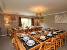 A dining room with a large table set for meals at Hazelgarth House in Hunmanby