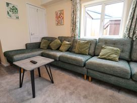A living room with a sofa and coffee table at Hazelgarth House in Hunmanby