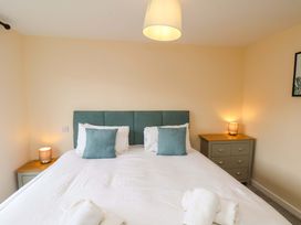 A bedroom with a bed and nightstand at Hazelgarth House in Hunmanby
