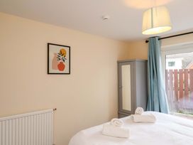 A bedroom with a bed and wardrobe at Hazelgarth House in Hunmanby