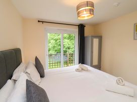 A bedroom with a bed and wardrobe at Hazelgarth House in Hunmanby