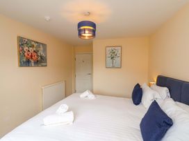 A bedroom with a bed and paintings on the walls at Hazelgarth House in Hunmanby