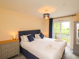 A bedroom with a bed and dresser at Hazelgarth House in Hunmanby
