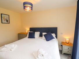 A bedroom with a bed and side tables at Hazelgarth House Hunmanby