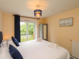A bedroom with a bed and window at Hazelgarth House in Hunmanby