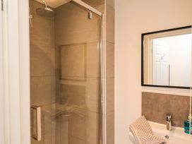 A bathroom with a shower and sink at Hazelgarth House Hunmanby