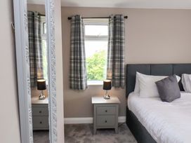 A bedroom with a bed and nightstand at Hazelgarth House in Hunmanby