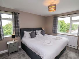 A bedroom with a bed and bedside table at Hazelgarth House in Hunmanby