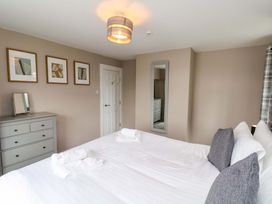 A bedroom with a bed and dresser at Hazelgarth House in Hunmanby