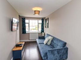 A living room with a sofa and television at Hazelgarth House in Hunmanby