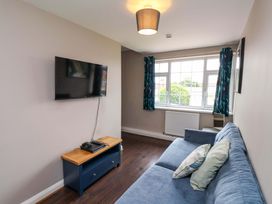 A living room with a television and sofa at Hazelgarth House in Hunmanby