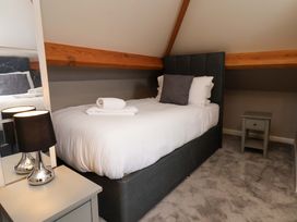 A bedroom with a bed and bedside table at Hazelgarth House in Hunmanby