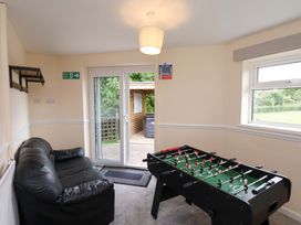 A game room with a foosball table and sofa at Hazelgarth House in Hunmanby