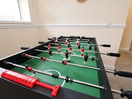 A foosball table with player figures and score counter at Hazelgarth House, Hunmanby