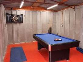 A games room with a pool table and dartboard at Hazelgarth House in Hunmanby
