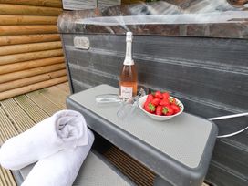 A hot tub with a champagne bottle and strawberries at Hazelgarth House in Hunmanby