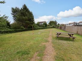 A garden with a picnic table and trees at Hazelgarth House in Hunmanby