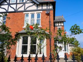 A house with a rose bush in front at Fern Lee in Carlisle