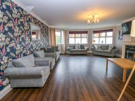 A living room with sofas and a table at Fern Lee in Carlisle