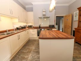 A kitchen with cabinets and appliances at Fern Lee in Carlisle