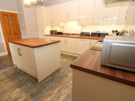 A kitchen with an island and appliances at Fern Lee in Carlisle