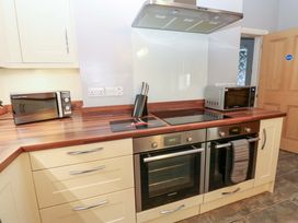 A kitchen with an oven, microwave, and cooker at Fern Lee in Carlisle