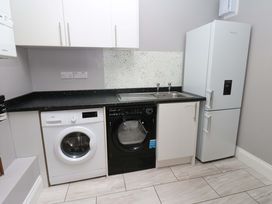A kitchen with a washing machine and refrigerator at Fern Lee in Carlisle