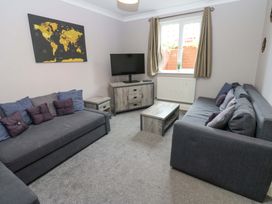 A living room with sofas and a television at Fern Lee in Carlisle