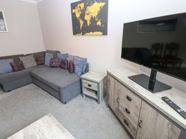 A living room with a sofa and television at Fern Lee in Carlisle