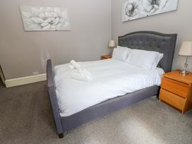 A bedroom with a bed and bedside tables at Fern Lee in Carlisle