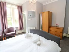 A bedroom with a bed and furniture at Fern Lee in Carlisle