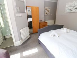 A bedroom with a bed and wardrobe at Fern Lee in Carlisle