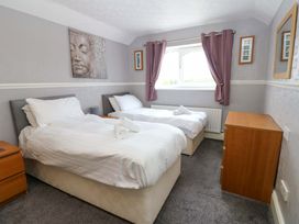 A bedroom with two single beds and a nightstand at Fern Lee in Carlisle