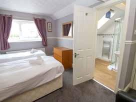 A bedroom with two beds and an ensuite bathroom at Fern Lee in Carlisle