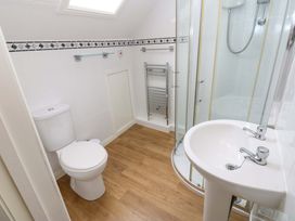 A bathroom with a shower, toilet, and wash basin at Fern Lee in Carlisle