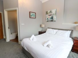 A bedroom with a bed and a toilet in an adjacent room at Fern Lee in Carlisle