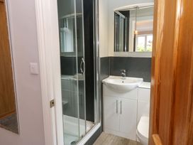 A bathroom with a shower, sink, and toilet at Fern Lee in Carlisle