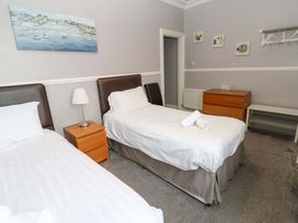 A bedroom with two beds and a painting at Fern Lee in Carlisle