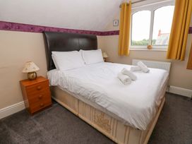 A bedroom with a bed and nightstand at Fern Lee in Carlisle