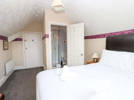 A bedroom with a bed and en-suite bathroom at Fern Lee in Carlisle